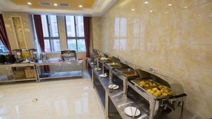 A buffet setup with multiple food stations, a long counter, and a tiled wall. - GreenTree Inn Hefei Feixi County South Jinzhai Road Jinyun International Hotel (Hefei)