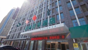 A hotel building with multiple floors, a prominent sign with Chinese characters, and flags of China and the United States. - GreenTree Inn Hefei Feixi County South Jinzhai Road Jinyun International Hotel (Hefei)