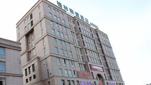 Een meerhoog hotel met een opvallend bord bovenop.