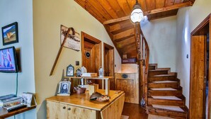 A wooden staircase leading to a loft bedroom with a sloped ceiling. - Kum Pansiyon  (Amasra)