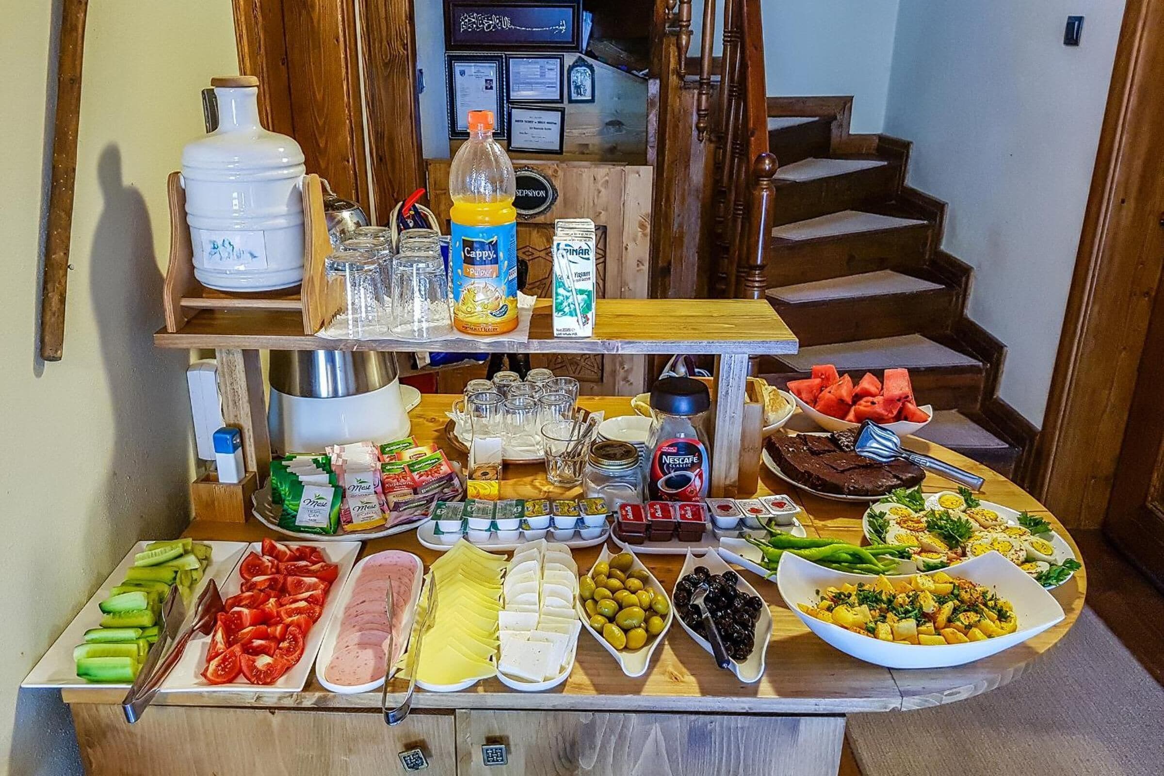 A buffet table with various food items and condiments.