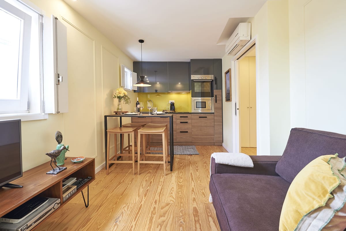 A compact living space with a kitchenette, a dining area, and a seating area.