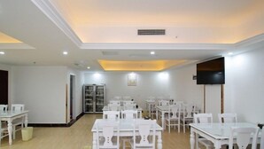 A spacious room with white furniture, a flat-screen TV, and a refrigerator. - GreenTree Inn HeFei Heyu Road Dayun City Express Hotel (Hefei)
