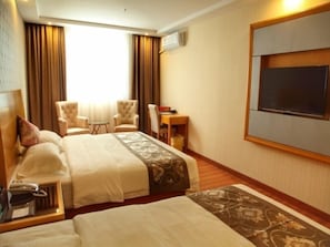 A hotel room with two beds, a desk, a chair, a TV, and a window with curtains. - GreenTree Inn Zhuhai Light Rail Pearl Station Express Hotel (Zhuhai)
