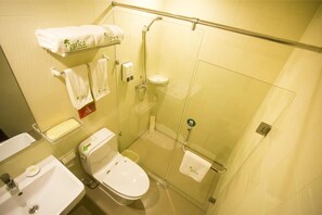 A bathroom with a toilet, sink, and glass shower enclosure. - Vatica Shanghai Jiading District Anting Metro Station Volkswagen Factory Hotel (Shanghai)