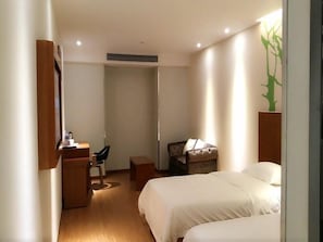 A hotel room with a bed, a desk, a chair, and a small table. - Vatica Suzhou Changshu Shimao Residence Hotel (Suzhou)