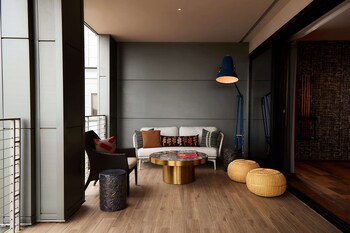 A restaurant with wooden walls, a central seating area, and tables set for dining. at The Nash