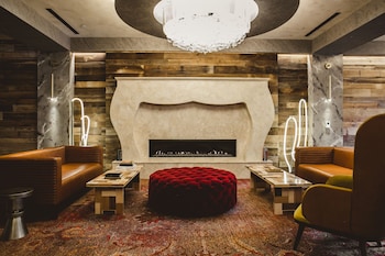 A modern living room with a sofa, coffee table, and floor lamp. at The Nash