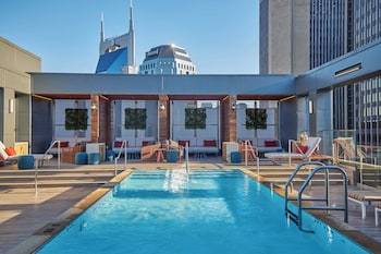 Relax by the rooftop pool with a stunning city view. at Bobby Hotel