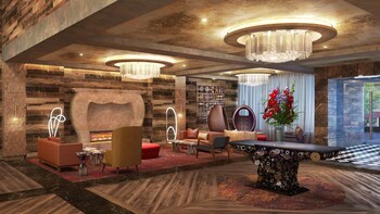 Relax in the stylish lounge area with a central seating space, fireplace, and elegant lighting. at Bobby Hotel