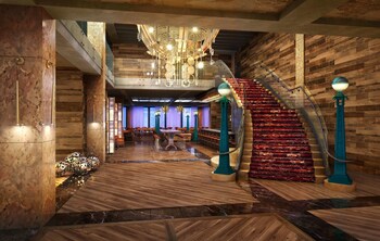 Stunning interior with a grand staircase, wooden paneling, and polished stone floors. at Bobby Hotel