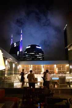 Relax in a spacious area with a stylish bar and seating area, separated by a sleek partition. at Bobby Hotel