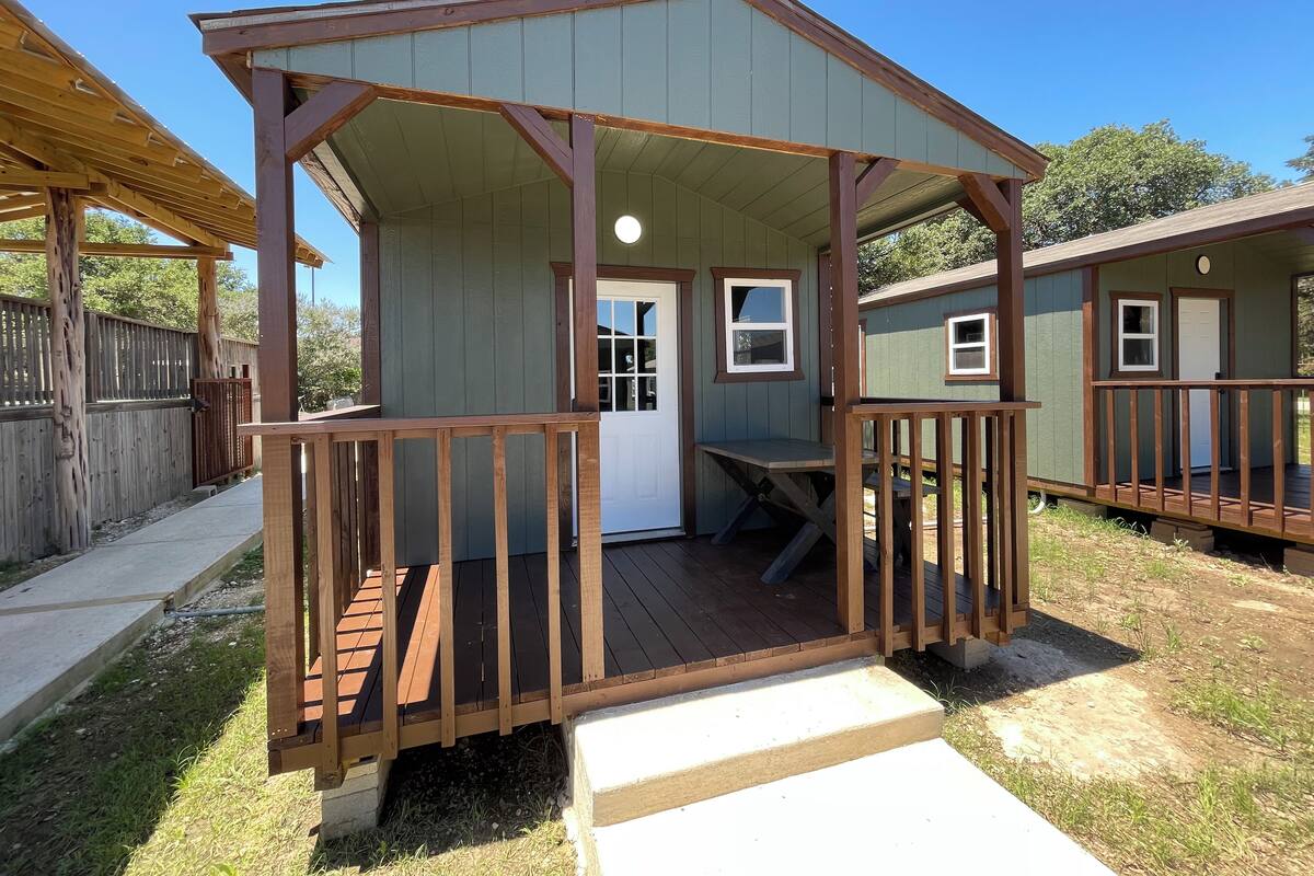 A small, single-story cabin with a porch and a door.