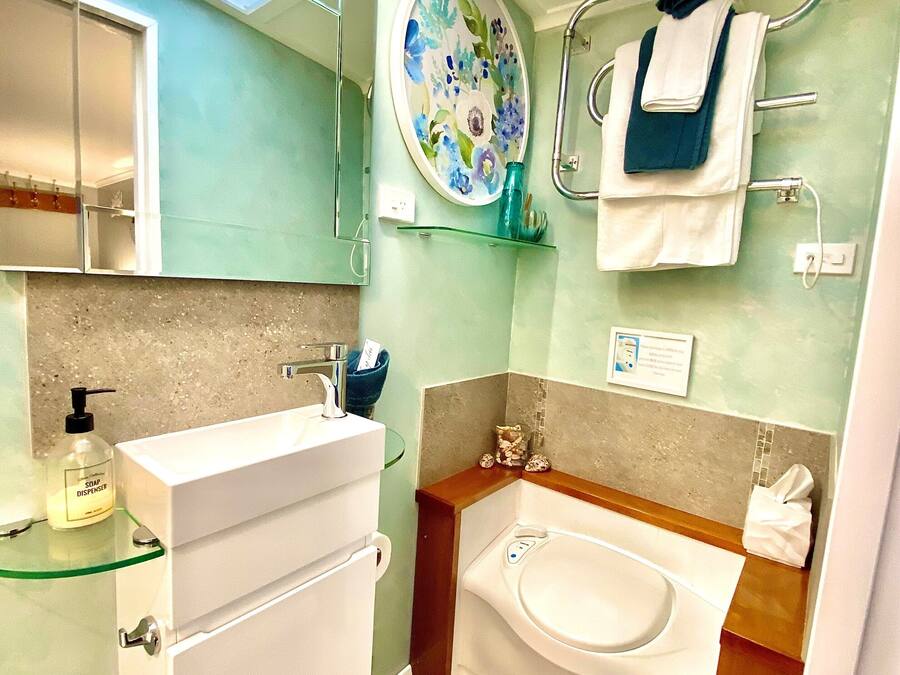 A modern bathroom with a glass shower enclosure, a white sink, and a bathtub.
