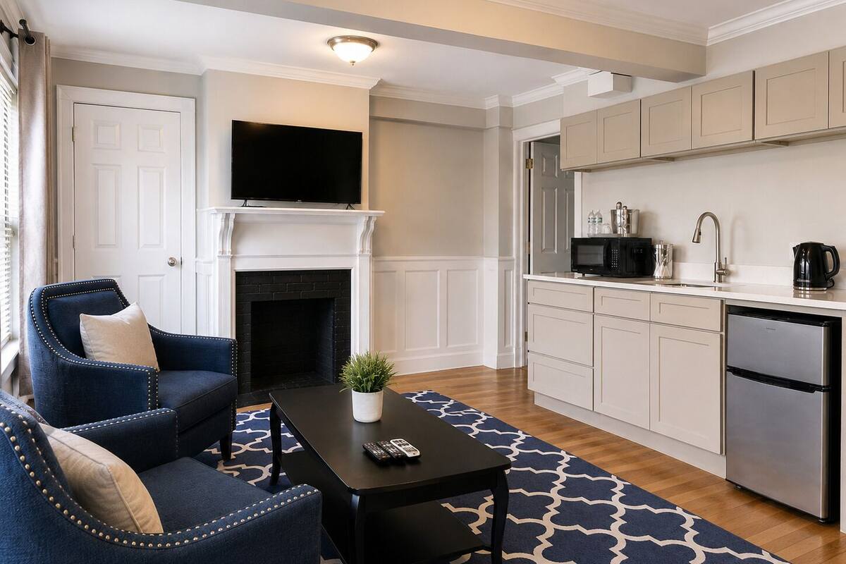 A modern living room with a fireplace, a flat-screen TV, a sofa, and a coffee table.