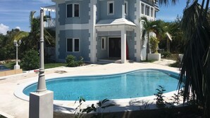 A two-story house with a swimming pool in front. - Blue Orchid Villa (Moss Town)