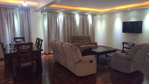 Executive Apartment, 3 Bedrooms, Balcony | Living area | 48-inch flat-screen TV with satellite channels, TV - Tomax Apartments Brooks (Nairobi)