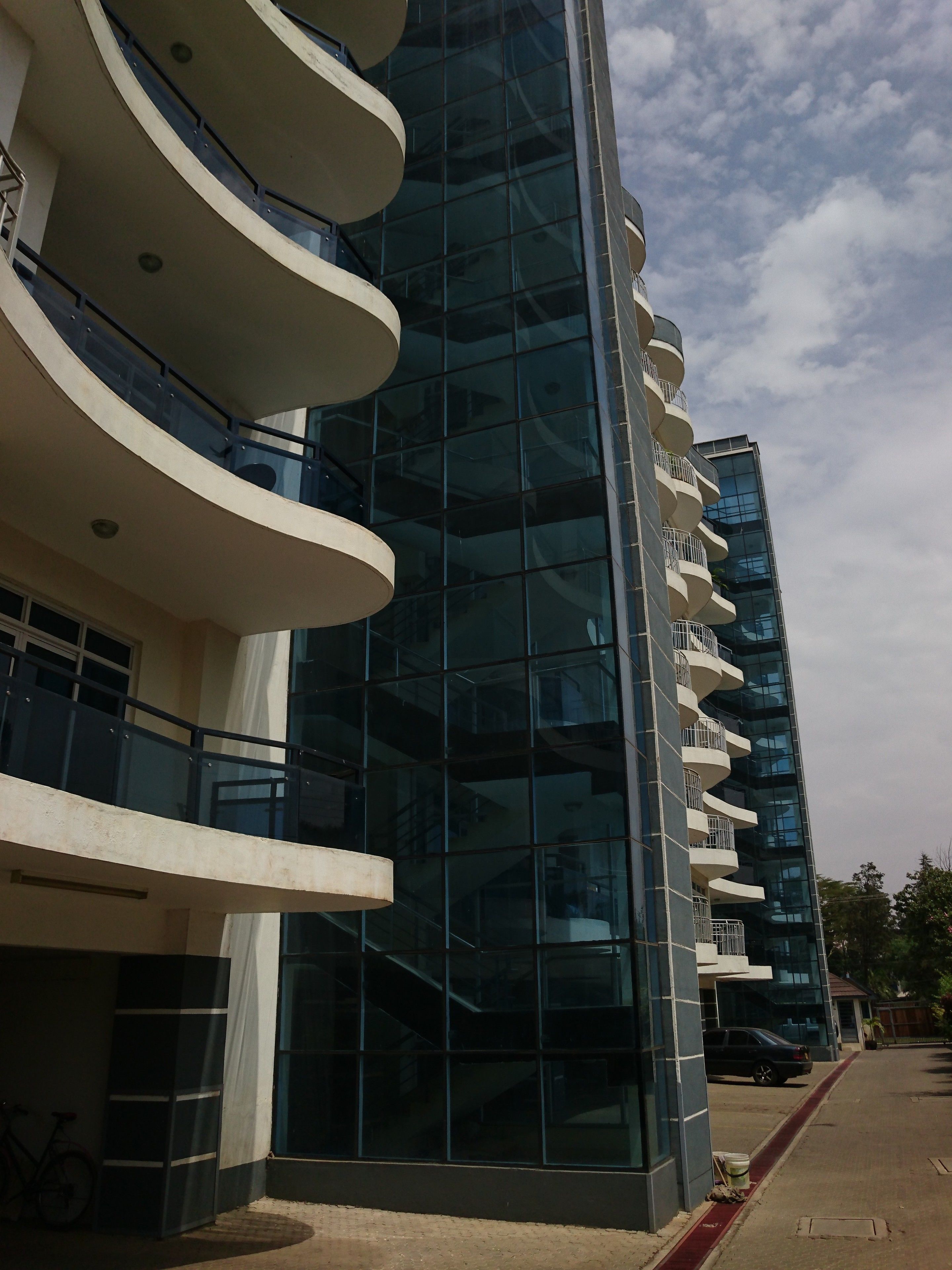 A modern building with multiple balconies and large windows.