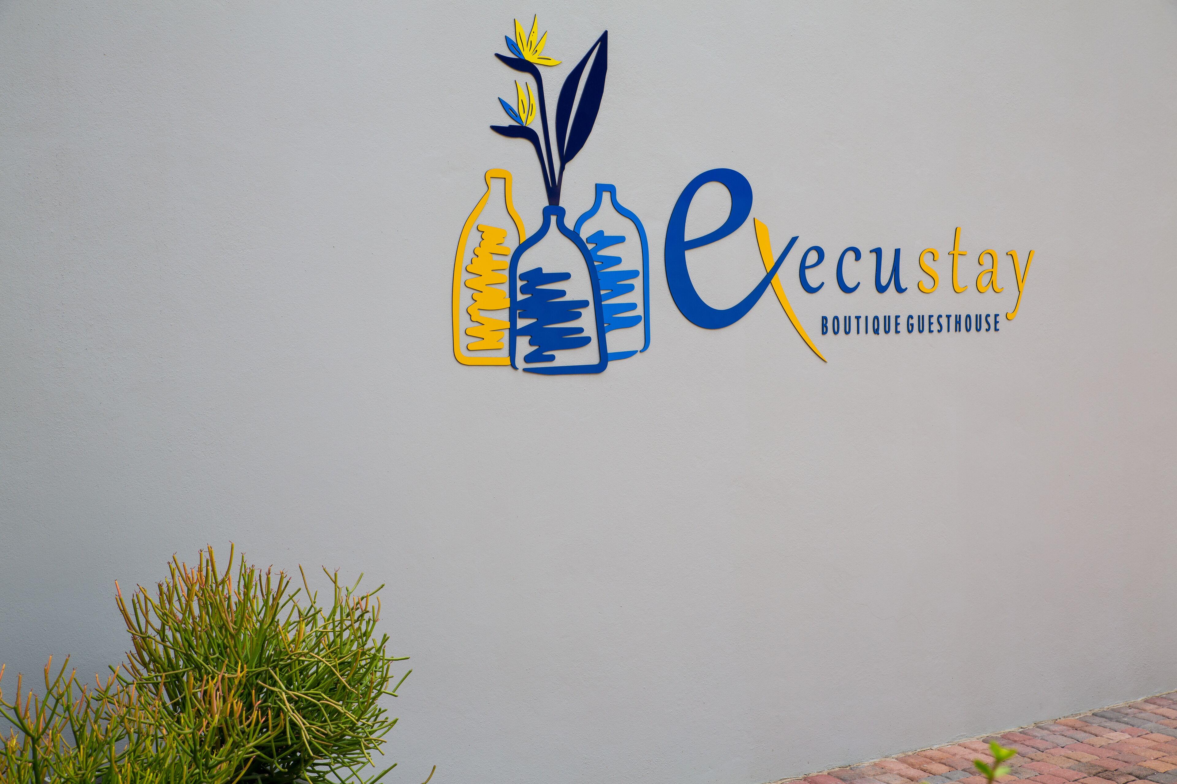 A logo with three bottles and a plant, and the text "ecustay Boutique Guesthouse".