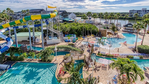 A water park with multiple pools, slides, and a large water slide.