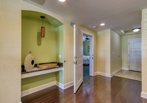 A hallway with a wooden floor, a white door, and a ceiling fan. - New Hotel Collection Harbourside Resort (Indian Rocks Beach)