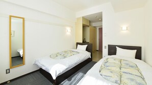 A hotel room with two single beds, a large mirror, and a small bedside table. - Refre Forum (Tokyo)