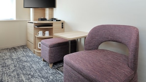 A hotel room with a desk, a flat-screen TV, a purple chair, and a coffee maker. - Keio Presso Inn Kudanshita (Tokyo)