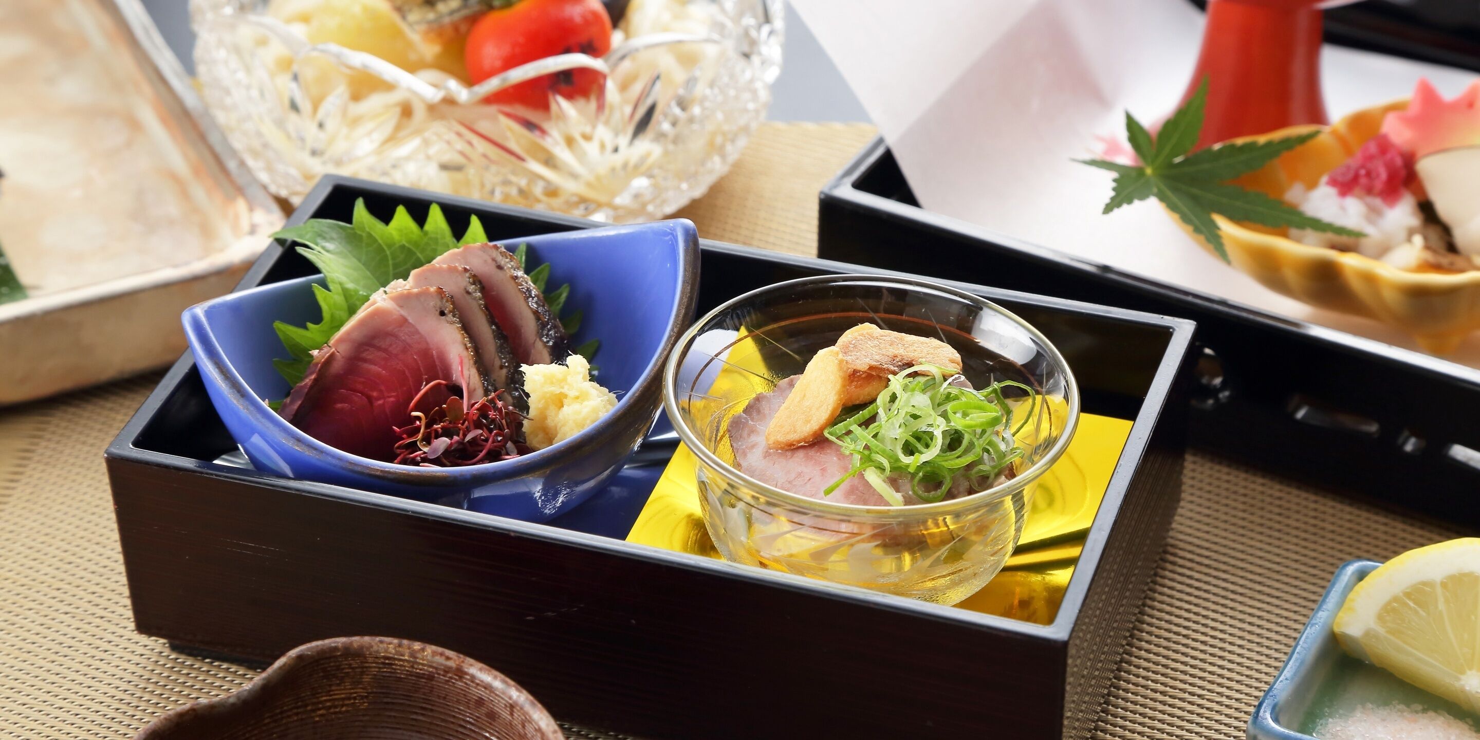 A traditional Japanese meal with sashimi and a small bowl of soup.