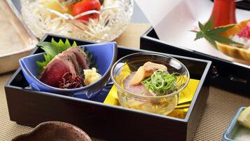 A traditional Japanese meal with sashimi and a small bowl of soup.