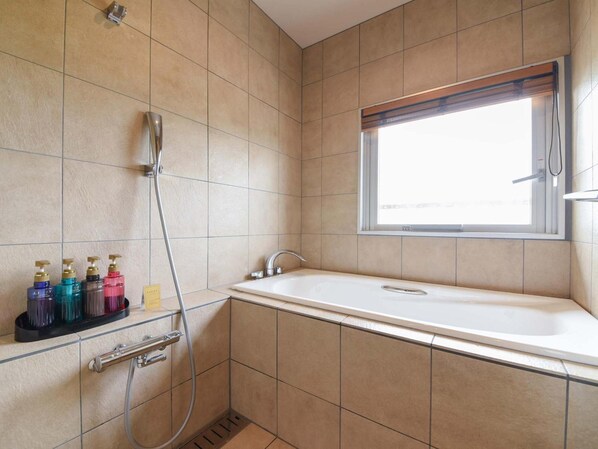 A bathroom with a bathtub, a shower, and a window. - Hotel The Day Osaka (Osaka)