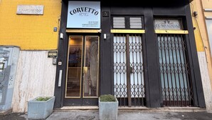 A hotel entrance with a sign reading "HOTEL CORVETTO" and flags of the USA, France, and Italy. - Albergo Corvetto corso Lodi (Milan)