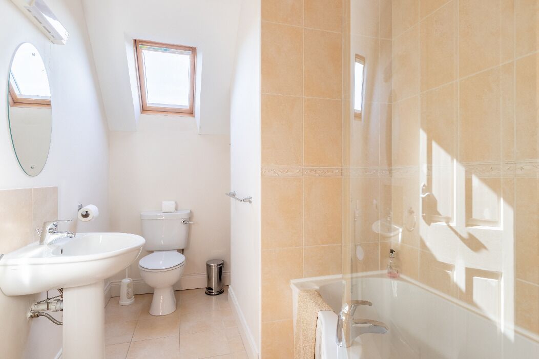 A bathroom with a sink, toilet, and bathtub.