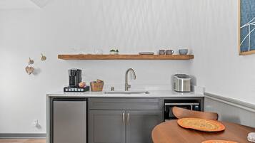 Fridge, microwave, coffee/tea maker, cookware/dishes/utensils