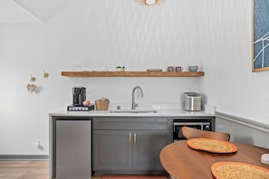 Fridge, microwave, coffee/tea maker, cookware/dishes/utensils