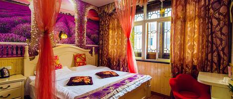 A bedroom with a bed, curtains, a nightstand, a chair, and a window.
