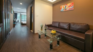 Un salón moderno con una mesa de centro de vidrio, sofá de cuero y un cuadro en la pared.