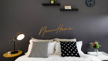 Premium bedding, desk, laptop workspace, iron/ironing board