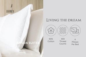 A bed with white bedding and a pillow, labeled "Panda Suites."