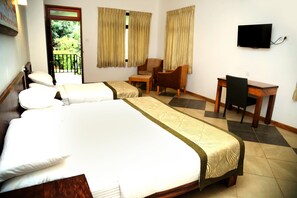 A hotel room with two beds, a desk, a chair, a television, and a balcony with curtains. - The Spring Villas (Kandy)