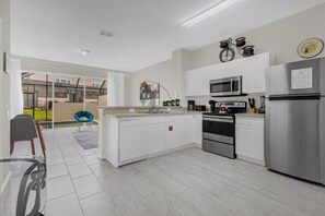 Enjoy cooking in this well-lit kitchen with oven, microwave, and dishwasher, plus a large island with a sink.