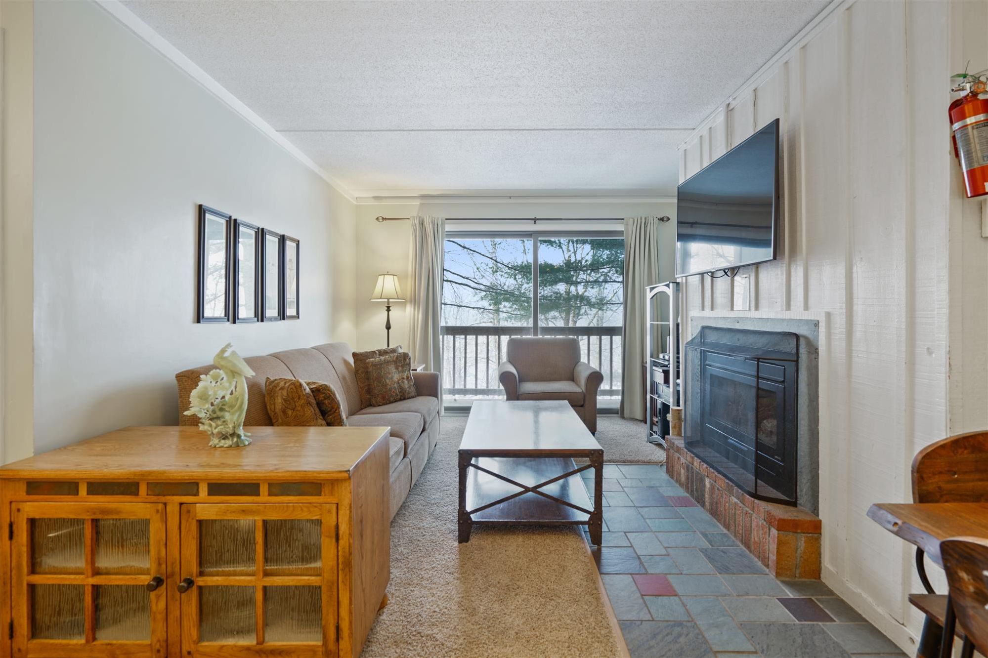 Bright and Comfortable Living Room - Large windows fill the space with natural light, offering a relaxing setting to unwind.