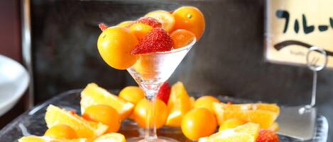 A glass plate with sliced oranges and strawberries.