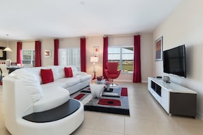 Relax in this stylish living room with a sofa, armchair, and flat-screen TV.