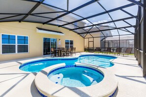 A covered outdoor swimming pool area with a hot tub, seating, and a patio. - ⛱ Marbella Resort - Disney Area - Extended Pool Deck & SPA - Games Room ☀ (Davenport)