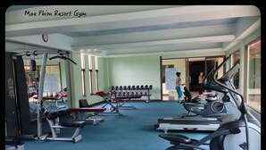 A gym with treadmills, elliptical machines, and weight benches. - 3 bdrm, 3 ba home with 24 hr security in private Villa. Located nr beach & pools (Kram)