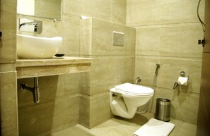 A modern bathroom with a sink, toilet, and shower.