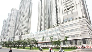 A high-rise building with multiple floors, large windows, and a modern architectural design. - Sunrise City 2BR Luxury SWPool 30th (Ho Chi Minh City)