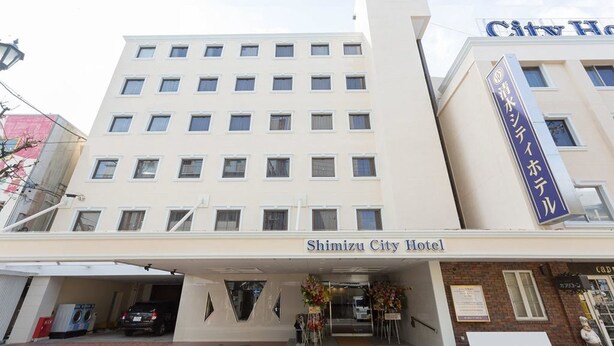 A hotel with a flat facade, multiple windows, and a sign reading "Shimizu City Hotel". - Shimizu City Hotel (Shizuoka)