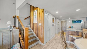 A staircase with wooden steps and a white door at the top. - Unit 37, Sea Haven, 2 Bedroom Beach Condo (Panama City Beach)