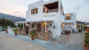 Relax in our welcoming outdoor patio area with comfortable seating and lush greenery.